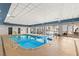 Indoor pool area with inviting blue water, tables, and seating for residents at 211 E Flamingo Rd # 610, Las Vegas, NV 89169