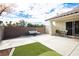 Spacious backyard with seating, synthetic grass and brick perimeter wall, ideal for relaxation and entertaining at 3576 Judah Way, Las Vegas, NV 89147