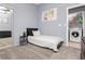 Cozy bedroom with a modern bed, grey walls, and a convenient laundry area nearby at 3576 Judah Way, Las Vegas, NV 89147