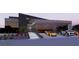 Modern home exterior with a glass-enclosed garage, displaying luxury cars and minimalist landscaping at 491 Cityview Ridge Dr, Henderson, NV 89012