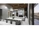 Bright open-concept living room with fireplace, modern lighting, dining area, and city views at 491 Cityview Ridge Dr, Henderson, NV 89012