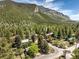 Aerial view of a residential area nestled in a mountain valley, showcasing numerous homes and lush greenery at 3968 Mont Blanc Way, Las Vegas, NV 89124