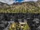 Aerial view showcasing a house surrounded by trees and mountains at 3968 Mont Blanc Way, Las Vegas, NV 89124