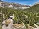 Aerial perspective showcasing a quiet residential street surrounded by beautiful mountain scenery and green trees at 3968 Mont Blanc Way, Las Vegas, NV 89124
