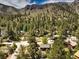 Aerial view of a residential area in a mountain setting, displaying houses with mountain views and green surroundings at 3968 Mont Blanc Way, Las Vegas, NV 89124