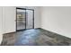 A bright bedroom features unique tiled flooring and sliding glass doors to the outside at 3427 Manzano Cir, Las Vegas, NV 89121