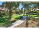 Well-manicured community grounds with lush green lawns, mature trees, and a paved walkway leading to the pool at 3427 Manzano Cir, Las Vegas, NV 89121