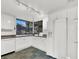 Bright kitchen with white cabinets, granite countertops, and a large window overlooking the lush backyard at 3427 Manzano Cir, Las Vegas, NV 89121