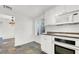Open kitchen with sleek appliances, white cabinetry, modern oven and cooktop with a tile backsplash at 3427 Manzano Cir, Las Vegas, NV 89121