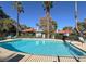 Sparkling community pool with palm trees and lounge chairs, perfect for relaxation and recreation at 3427 Manzano Cir, Las Vegas, NV 89121