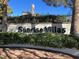 Community entrance sign for Sunrise Villas, surrounded by lush greenery and a brick wall at 3427 Manzano Cir, Las Vegas, NV 89121