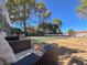 Relaxing view of the tennis courts from the patio seating area surrounded by mature landscaping at 3427 Manzano Cir, Las Vegas, NV 89121