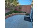 Cozy backyard featuring artificial turf, planters, trees, brick retaining wall, and concrete patio at 11261 Playa Caribe Ave, Las Vegas, NV 89138