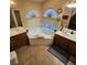 Elegant bathroom with dual sinks, a luxurious soaking tub, and stylish fixtures at 11261 Playa Caribe Ave, Las Vegas, NV 89138