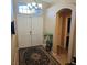 Inviting foyer with neutral tones, tile floor, white double doors, and decorative rug at 11261 Playa Caribe Ave, Las Vegas, NV 89138