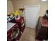 Practical laundry room with red washer/dryer, storage, and tile flooring at 11261 Playa Caribe Ave, Las Vegas, NV 89138