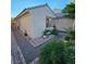 Well-maintained side yard with gravel, pavers, and neat landscaping, offering a clean, tidy look at 11261 Playa Caribe Ave, Las Vegas, NV 89138