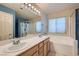 Bathroom showcasing double sinks, bathtub, and separate shower at 2731 Heathrow St, Las Vegas, NV 89135