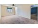 A spacious bedroom featuring neutral walls, carpet floors, a ceiling fan and natural light from a window at 2731 Heathrow St, Las Vegas, NV 89135