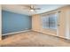 Bedroom with ceiling fan, neutral walls, and large window at 2731 Heathrow St, Las Vegas, NV 89135