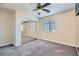 Carpeted bedroom with mirrored sliding door closet and ceiling fan at 2731 Heathrow St, Las Vegas, NV 89135