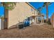 Exterior home view displaying a covered patio, rock landscaping, and palm trees at 2731 Heathrow St, Las Vegas, NV 89135