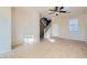 Neutral living room with tile flooring, open staircase, and bright white front door at 2731 Heathrow St, Las Vegas, NV 89135