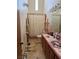 Bathroom featuring tile flooring, a ruffled shower curtain and pink tiling details above the vanity at 555 Cooper St, Overton, NV 89040