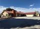 Single story home with a terracotta-colored roof and an ample parking area at 555 Cooper St, Overton, NV 89040