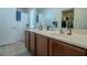 Clean bathroom with double vanity and large mirror at 10111 Aspen Rose St # 101, Las Vegas, NV 89183