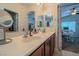 Elegant bathroom with double vanity and view into bedroom at 10111 Aspen Rose St # 101, Las Vegas, NV 89183