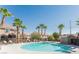 Inviting community pool with surrounding lounge chairs at 10111 Aspen Rose St # 101, Las Vegas, NV 89183