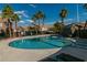 Community pool with lounge chairs and surrounding landscaping at 10111 Aspen Rose St # 101, Las Vegas, NV 89183