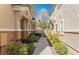 Townhome side with walkway, landscaping, and gate at 10111 Aspen Rose St # 101, Las Vegas, NV 89183