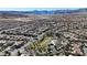 Sweeping aerial view of a residential community near recreational areas, featuring a picturesque landscape and tree-lined streets at 11605 Cabo Del Sol Ct, Las Vegas, NV 89138