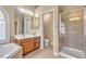 Bright bathroom featuring double sinks, soaking tub, and glass enclosed shower at 11605 Cabo Del Sol Ct, Las Vegas, NV 89138