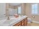 Bathroom vanity features dual sinks, cherry cabinets, and a large mirror at 11605 Cabo Del Sol Ct, Las Vegas, NV 89138