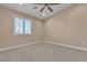 Bright bedroom with neutral tones, carpet flooring and a ceiling fan at 11605 Cabo Del Sol Ct, Las Vegas, NV 89138