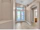 Inviting entryway with decorative glass doors, tile flooring, and a modern chandelier at 11605 Cabo Del Sol Ct, Las Vegas, NV 89138