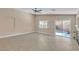 Open living room area featuring backyard access, tile flooring, neutral paint, and contemporary ceiling fan at 11605 Cabo Del Sol Ct, Las Vegas, NV 89138