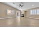 Bright living room featuring fireplace, tile flooring, and backyard access through sliding doors at 11605 Cabo Del Sol Ct, Las Vegas, NV 89138