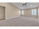 Bright main bedroom with plush carpet, multiple windows, and neutral paint at 11605 Cabo Del Sol Ct, Las Vegas, NV 89138