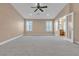 Expansive main bedroom with cozy carpet, ceiling fan, and bright natural light at 11605 Cabo Del Sol Ct, Las Vegas, NV 89138