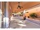 Covered patio with ceiling fans, stamped concrete, and a desert landscaped wall at 11605 Cabo Del Sol Ct, Las Vegas, NV 89138