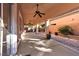 Covered patio with ceiling fans, stamped concrete, and a desert landscaped wall at 11605 Cabo Del Sol Ct, Las Vegas, NV 89138