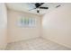 Well-lit bedroom with tile floors and window at 4386 El Carnal Way, Las Vegas, NV 89121