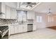 Modern kitchen with white cabinets, stainless steel appliances, and tile floor at 4386 El Carnal Way, Las Vegas, NV 89121