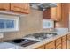 Gas cooktop, granite countertops, and ample wood cabinetry at 866 La Sconsa Dr, Las Vegas, NV 89138