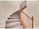 Elegant curved staircase with wood railing and carpet at 866 La Sconsa Dr, Las Vegas, NV 89138