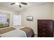 Secondary bedroom with ceiling fan and dresser at 8737 Red Brook Dr # 103, Las Vegas, NV 89128